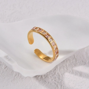 Minimalist gold-plated open ring with square cubic zirconia stones on stone tray
