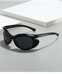 Detail view of glossy black wraparound cat-eye sunglasses with futuristic side shields