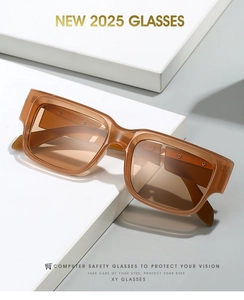 Detail view of stylish thick amber frames on a white pedestal with sharp shadows