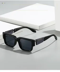 Close-up of black chunky square sunglasses with silver metal hinge detail on white blocks