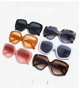 Flat lay of retro oversized square sunglasses in six assorted colors on a white background