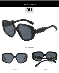 Detail view of large black frame sunglasses with golden chain metal hinge decoration