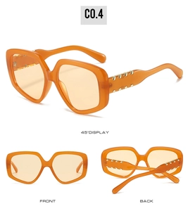 Three views showing orange oversized geometric sunglasses with gold metal rivet accents