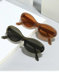 Close-up of retro oval sunglasses with metal hinges in caramel brown and dark green