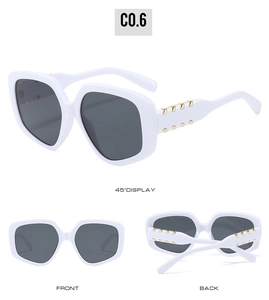 Detailed views of white oversized sunglasses featuring gold metal accents on temples