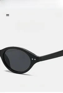 Close-up of small frame sunglasses hinges with silver metal rivets on black frame