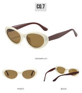 Detail view of oval white frame sunglasses with brown lenses and dark brown temples