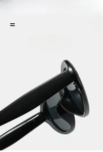 Macro detail of glossy black sunglasses frame hinge showing lightweight elastic material