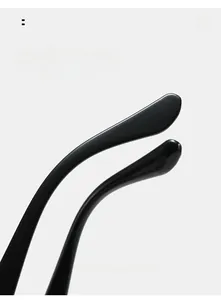 Close-up of sleek black curved temples on oval sunglasses for ergonomic comfort