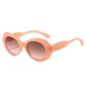 Lunettes de soleil ovales modernes rose poudré avec verres dégradés et détails dorés