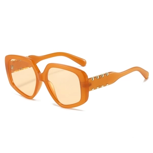 Modern oversized orange polygon sunglasses with gold metal decorative accents