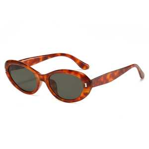 Vintage tortoiseshell oval cat-eye sunglasses with dark lenses and silver metal accents