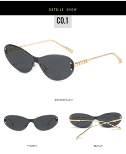 Detail view of cat eye sunglasses with gold cube temple design and grey lenses