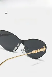 Detail of black rimless sunglasses with geometric gold temples and lightweight metal arms