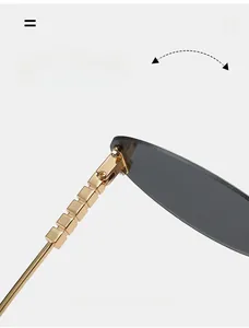 Detail of durable gold metal square-link hinge on trendy cat-eye sunglasses