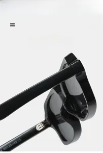 Detail view of the metal hinge and frame specs on black square fashion sunglasses