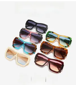 Close-up of stylish oversized square sunglasses in various colors with gradient lenses