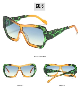 Detail view of square sunglasses featuring green and yellow leopard print with gradient lenses