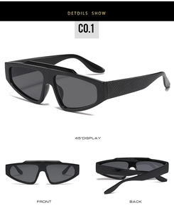 Macro detail of irregular black sunglasses with embossed texture and integrated shield lens