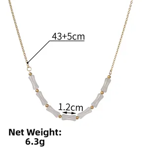 Macro detail of a 43+5cm bamboo joint necklace with gold beads and white tubes