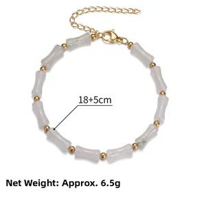 Detail of green bamboo bead bracelet with gold accents and lobster clasp, 18+5cm length