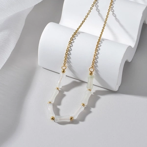 Minimalist stainless steel necklace with gold chain and translucent bamboo beads