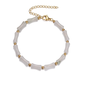 Detail of bamboo-style bracelet with faux jade beads and gold-plated metal spacers