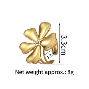 Golden five-petal flower ring with central crystal and matte finish on white background