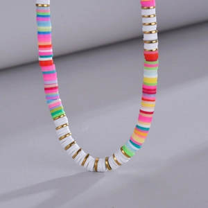 Colorful bohemian style clay bead necklace with gold spacers and white accents