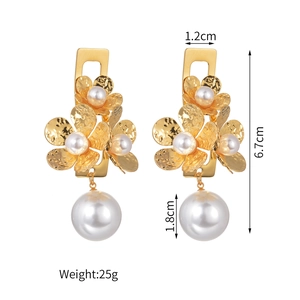 Detail of gold flower earrings with white pearls showing 6.7cm length and 25g weight