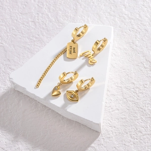 Set of four gold stainless steel hoop earrings with heart and letter charms