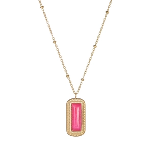 Detailed view of a vintage gold necklace featuring a square red gemstone pendant with ornate edges