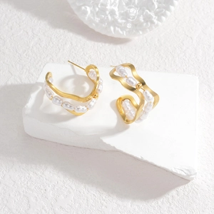 Minimalist wavy gold pearl earrings with asymmetric baroque style on stone base