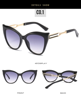 Detail view of black cat eye sunglasses with golden geometric cut-out metal temples