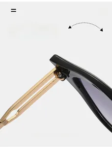 Close-up of durable golden metal hinges on stylish black cat-eye sunglasses
