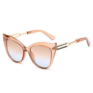 Cat eye sunglasses with amber frames, gradient lenses, and gold hollow metal temples