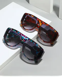 Detail view of colorful oversized wrap sunglasses on geometric display blocks