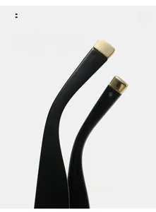 Detail of black curved sunglasses legs with golden metal tips for comfortable wear