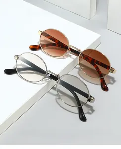 Detail view of oval tortoise shell and silver metal frame glasses on white platform