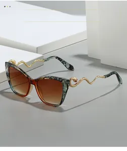 Detail of tortoise shell cat-eye sunglasses with luxury gold snake-shaped metal temples