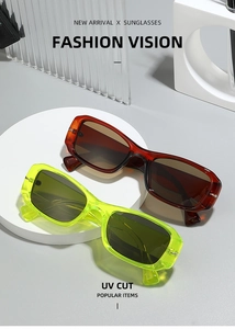 Detail of neon green and amber square sunglasses with metal hinges on geometric props