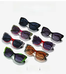 Flat lay view of cat-eye sunglasses in various colors and trendy leopard patterns