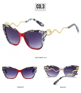 Detail view of cat-eye sunglasses with snake print frames and golden snake-shaped metal temples