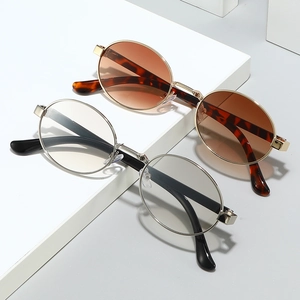 Vintage oval metal sunglasses set featuring tortoiseshell and black frames on a white platform