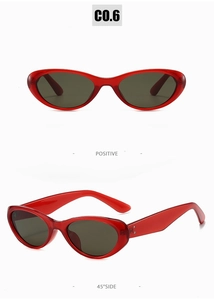 Détail de lunettes de soleil ovales rouges avec verres gris et rivets métalliques à 45 degrés