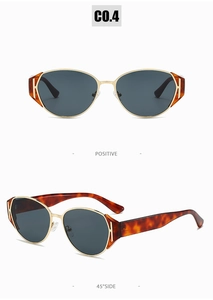 Detail of retro gold metal sunglasses with dark lenses and tortoise shell temples
