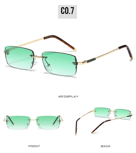 Detail view of rimless rectangle sunglasses with green gradient lenses and gold metal temples