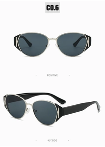 Close-up of silver metal frame sunglasses with H-shaped hinge and black temples