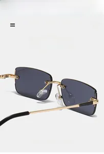 Close-up of lightweight frameless sunglasses with golden metal temples and grey lenses