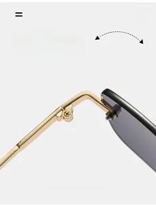 Macro shot of durable golden metal hinge and screws on rimless square sunglasses